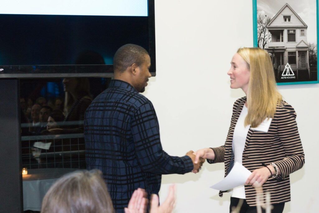 Yussuf shakes hands with Allison Steinhafel at the Longest Neighborhood Table event in September.