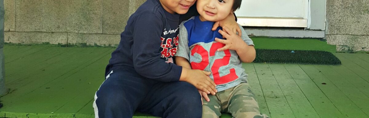 Martin and Angel play on the front porch of their new home and pose for a quick photo.