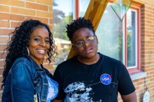Phoebe and her son in front of their home