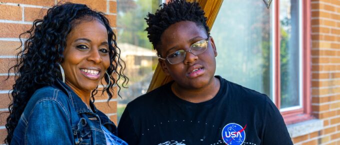 Phoebe and her son in front of their home